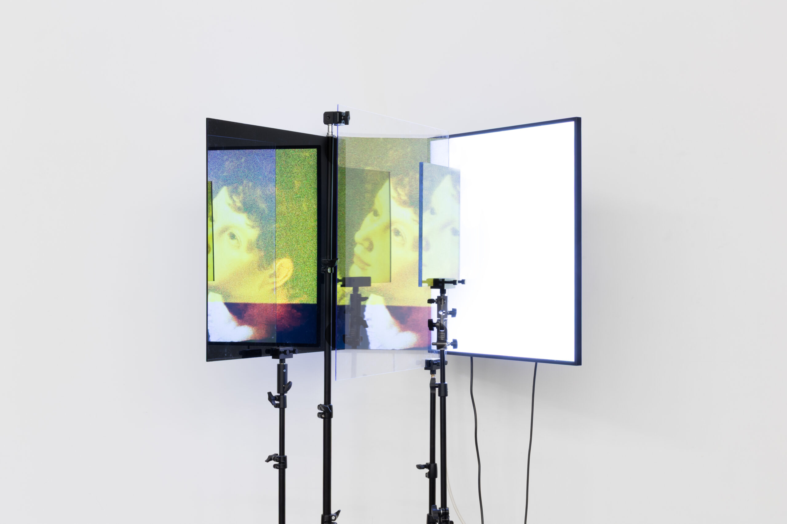Emmanuel Van der Auwera, Medusa 12.14.12, 2025, Square 33.2 inch LCD screen, polarization filter, plexiglass, tripods, HD video. Duration 15 mins 30 sec, 190 x 100 x 100 cm - 74 3/4 x 39 3/8 x 39 3/8 in. Photo credit: the artist