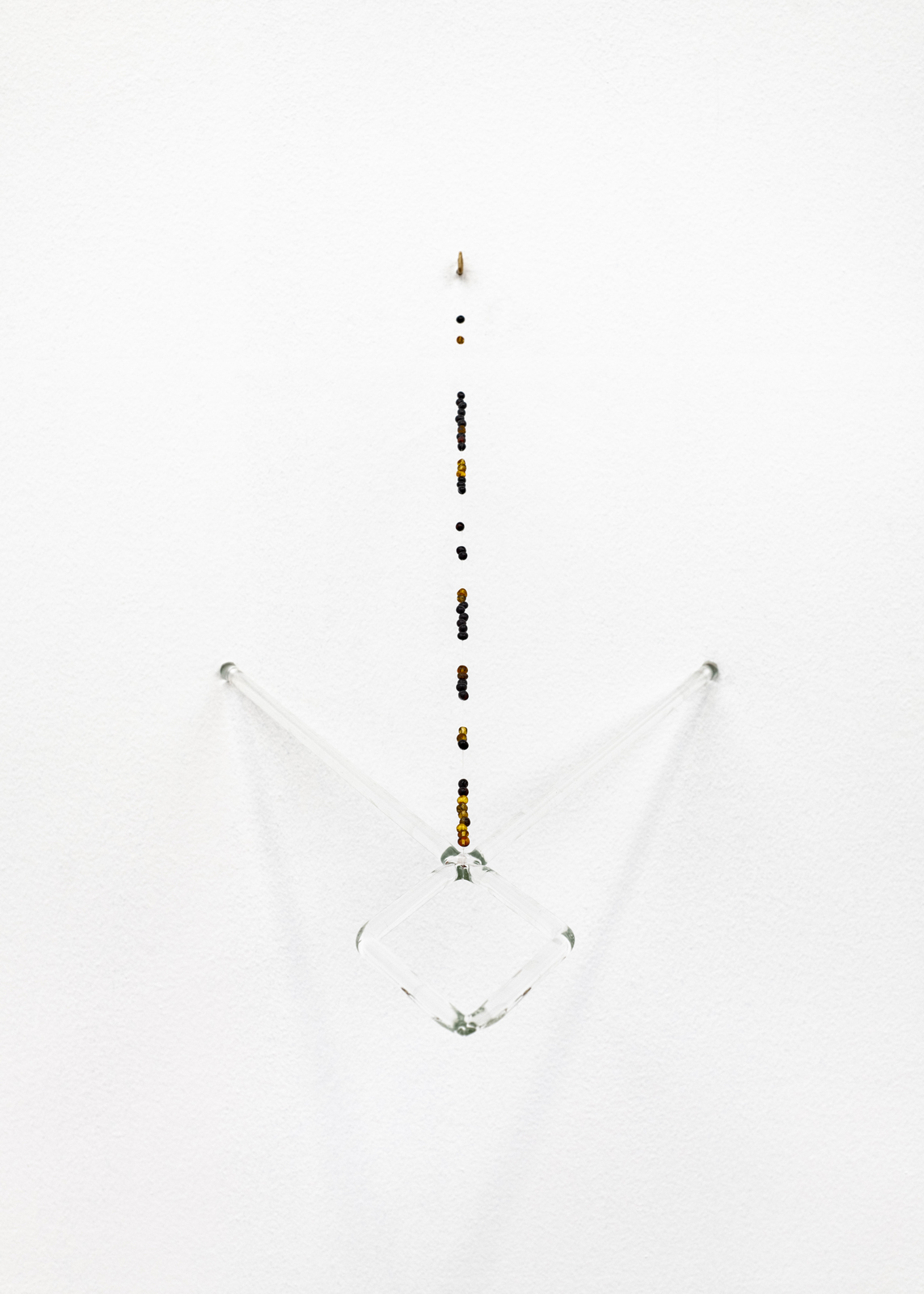 Sabine Mirlesse, Elektrod no 1, 2025, Baltic amber, borosilicate glass, sculpted brass hooks, fishing line, Unique, 42 x 37 cm.