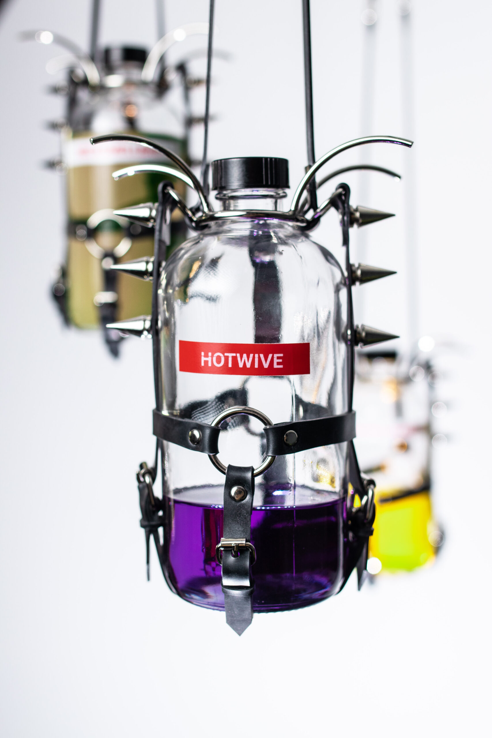 Selma Gültoprak, Little Love Monument, 2022
11 glass bottle, oil, pigments, labels, latex, spider mouth gag, o-rings, rivets, carabineer, steel link chain