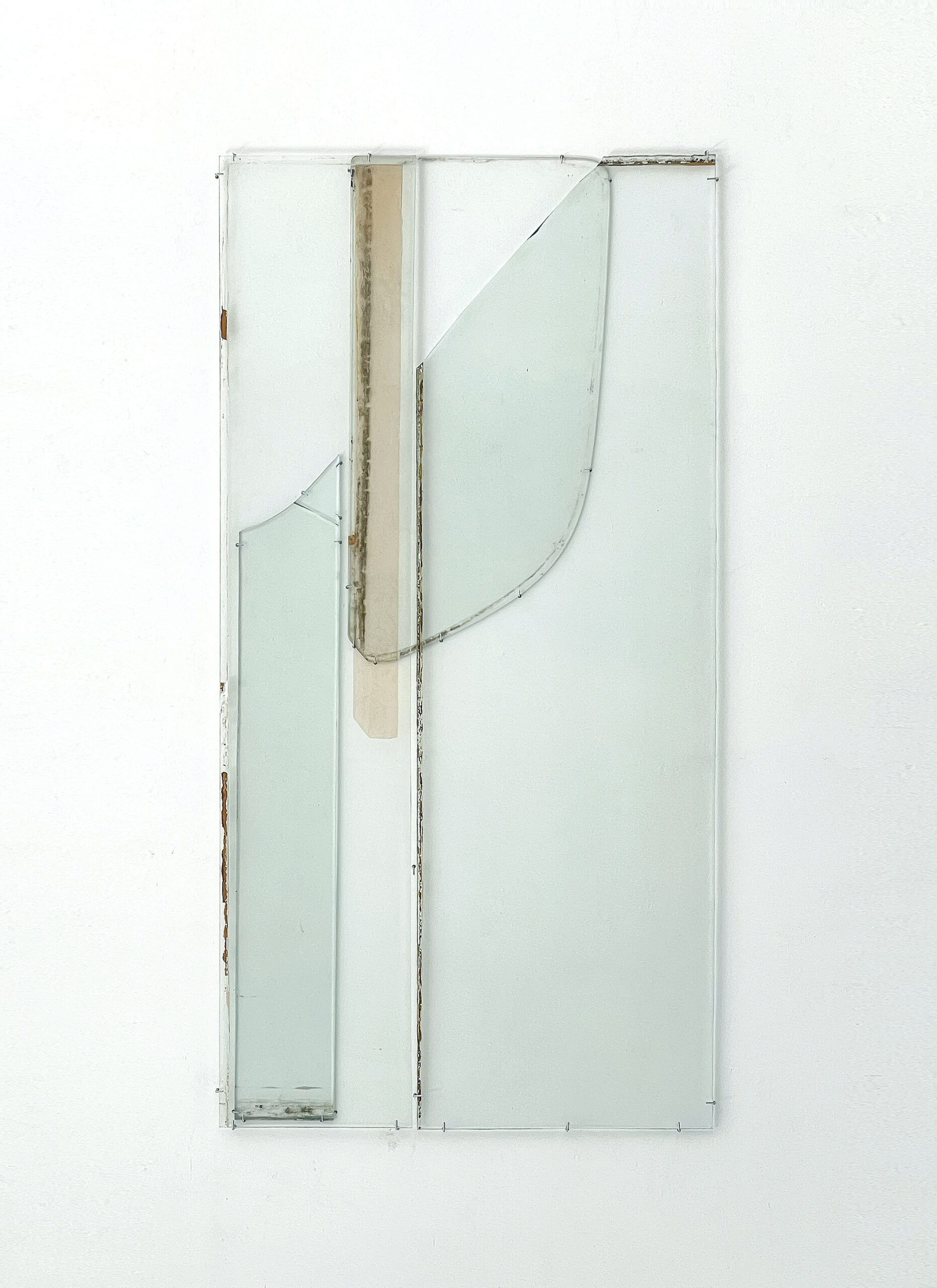 Anneke Eussen, Planning the past 01, 2025, car pane, recycled glass, coloured glass, metal hooks, mounted to the wall, 147 x 75 cm, unique